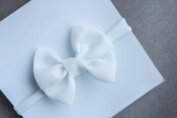 Handmade bow for a newborn top view, concept of expecting a baby