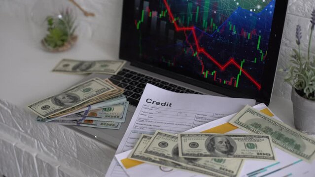 Economic crisis in the European Union. money banknotes on a laptop with falling chart hologram.