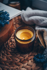 Candle and flowers in home atmospheric interior