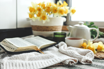 Open Bible in a cozy home interior. Good morning