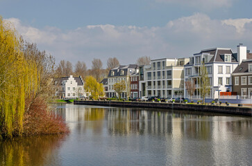 Fototapeta na wymiar Maarssen, The Netherlands, April 9, 2023: new neighbourhood with architecture in retro style on the bank of the river Vecht