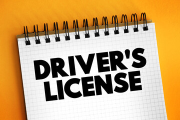 Driver's license - legal authorization confirming authorization to operate one or more types of motorized vehicles, text concept on notepad