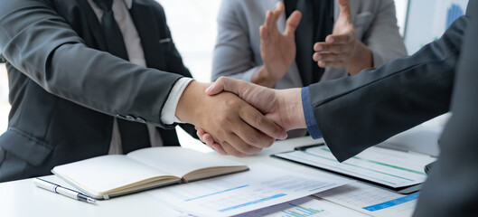 Business success. Business people handshake agreement confirmed in the investment business.