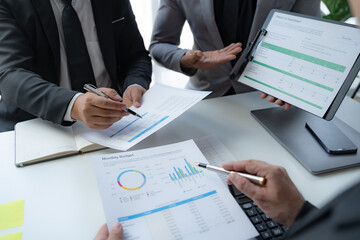 Business people meeting explaining the financial graph data and marketing plan. Group of business people at meeting assessment the state of business investment and marketing.
