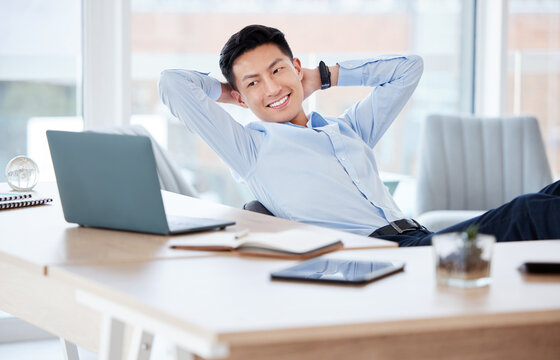 Let your work do the talking. Shot of a young businessman resting while working in a modern office.