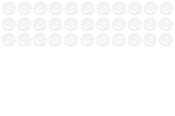 Drops of clear gel or water in rows. On a white background.