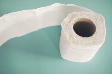 Simple toilet paper on blue background.