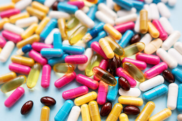 Lots of colorful pills and capsules for different symptoms. Concept of health and medicine.