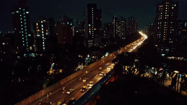 4K Aerial night footage of a busy traffic intersection illuminated with cars and street lights. Mumbai Skyline, Maharashtra, India. Indian City Mumbai at night