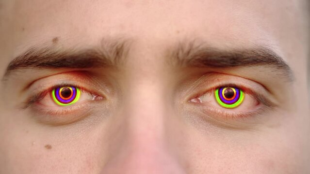 Colors change in eye pupils of young person extreme closeup