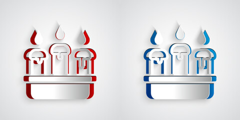 Paper cut Burning candle in candlestick icon isolated on grey background. Cylindrical candle stick with burning flame. Paper art style. Vector