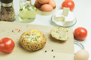 Bun with cheese and egg for breakfast. Sandwich with egg, bacon and cheese