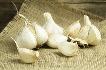Fresh garlic close-up, cloves of garlic on a wooden background.