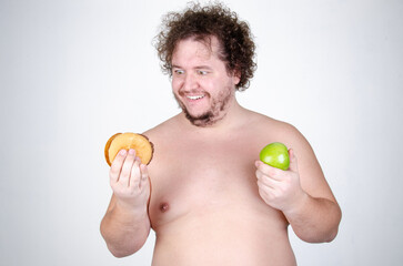 Diet and healthy lifestyle. Funny fat man eating a burger.