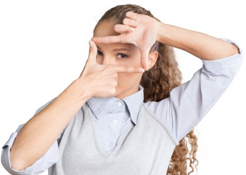 Beautiful young businesswoman making finger picture frame