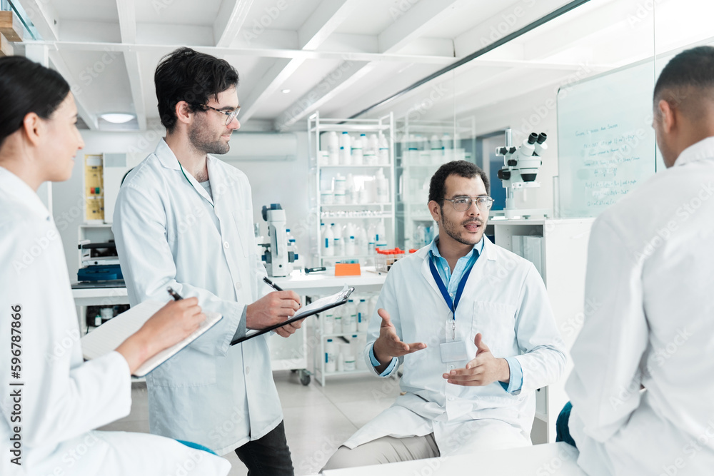 Poster Coming together to share facts and findings. Shot of a group of scientists working together in a lab.