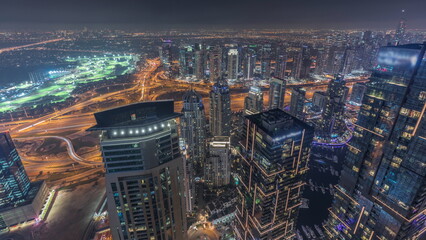 Obraz premium Panorama of Dubai Marina with JLT skyscrapers and golf course day to night timelapse, Dubai, United Arab Emirates.