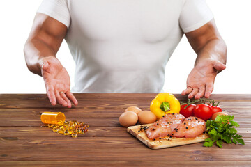 Male hands with meat and vegetables on wooden desk