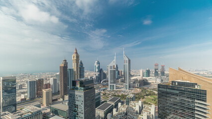 Naklejka na ściany i meble Panorama of futuristic skyscrapers in financial district business center in Dubai on Sheikh Zayed road timelapse
