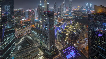 Fototapeta na wymiar Panorama of futuristic skyscrapers in financial district business center in Dubai night timelapse