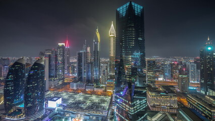 Panorama of futuristic skyscrapers in financial district business center in Dubai night timelapse