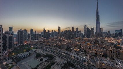 Fototapeta na wymiar Dubai Downtown day to night transition timelapse with tallest skyscraper and other towers