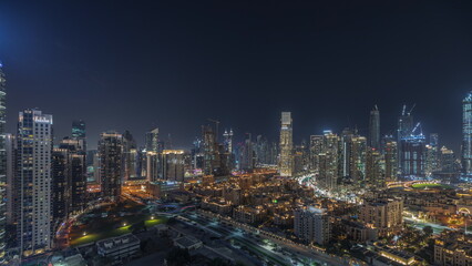 Obraz na płótnie Canvas Panorama showing Dubai Downtown and business bay night timelapse with tallest skyscraper and other towers