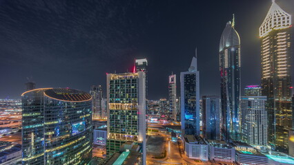 Obraz na płótnie Canvas Dubai international financial center skyscrapers aerial night timelapse.