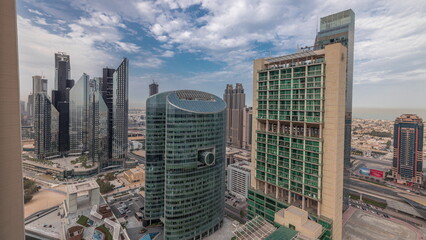 Panorama showing Dubai international financial center skyscrapers with promenade on a gate avenue aerial timelapse.