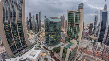 Panorama of Dubai international financial center skyscrapers aerial night to day timelapse.