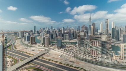 Naklejka na ściany i meble Panorama showing skyline of Dubai with business bay and downtown district timelapse.