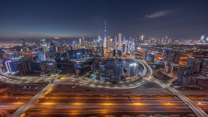Obraz na płótnie Canvas Panoramic skyline of Dubai with business bay and downtown district day to night timelapse.