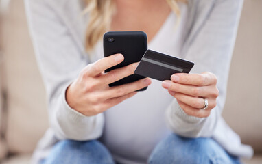 Im buying it now before its sold out. Closeup shot of an unrecognisable woman using a cellphone and credit card at home.