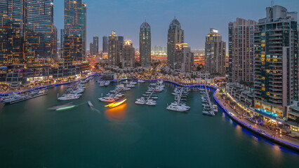 Fototapeta premium Luxury yacht bay in the city aerial day to night timelapse in Dubai marina