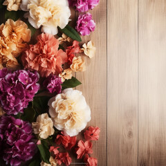 A wood background topped with lots of beautiful flowers. blank space. Abstract natural floral layout with text space and copy space. Wedding invitation. 
 Women, Mother's Day ai-generated