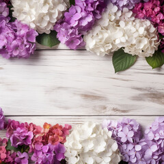 A white wood background topped with lots of beautiful white, pink and violet flowers , blank space and text space. Abstract natural floral layout with text space and copy space. Wedding invitation. In