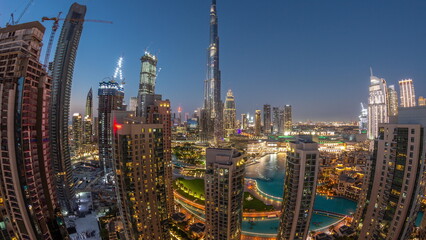 Dubai Downtown cityscape with tallest skyscrapers around aerial day to night timelapse.