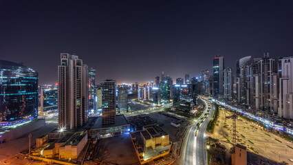 Fototapeta na wymiar Water canal with modern towers residential development in Business Bay aerial panoramic all night timelapse, Dubai