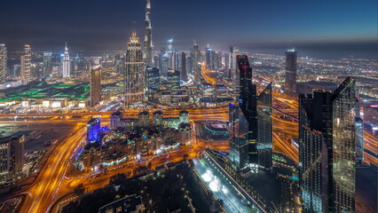 Obraz na płótnie Canvas Aerial view of tallest towers in Dubai Downtown skyline and highway day to night timelapse.