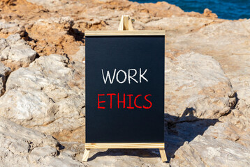 Work ethics symbol. Concept words Work ethics on beautiful black chalk blackboard on a beautiful stone background. Business and Work ethics concept. Copy space.