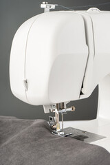 Modern sewing machine with gray fabric