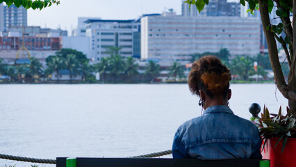a man standing in front of a lake in abidjan - Powered by Adobe