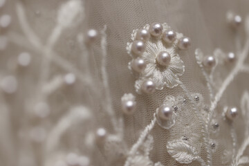 intricate design with pearls. Close up of detail on wedding gown