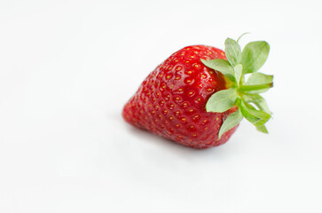 One red ripe fresh strawberry close-up on a white background. Fresh berries, summer harvest, fruits, healthy food, diet concept. 