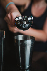 Barkeeper squezing a lemon with a hand juicer to prepare a pisco sour cocktail