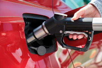 woman hand fueling car with Compressed Natural Gas (CNG)