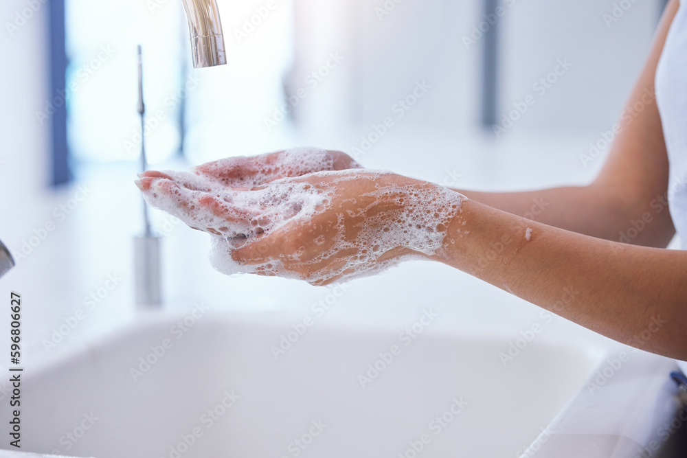 Poster Bacteria loves to hide, be thorough. Shot of an unrecognizable woman washing her hands at the kitchen sink.