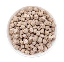 Oat bran extruded in a white bowl on a white background. View from above. Cut off the isolate. healthy eating