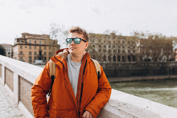 Happy young man walking on city street, Urban lifestyle concept. Traveler