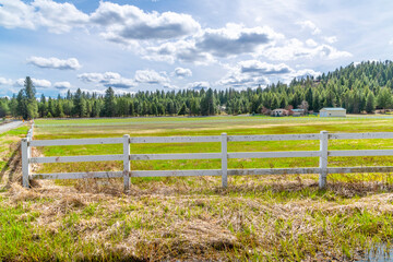 Tree covered hills and meadows with ranch homes and outbuildings in Newman Lake, a rural suburb of...